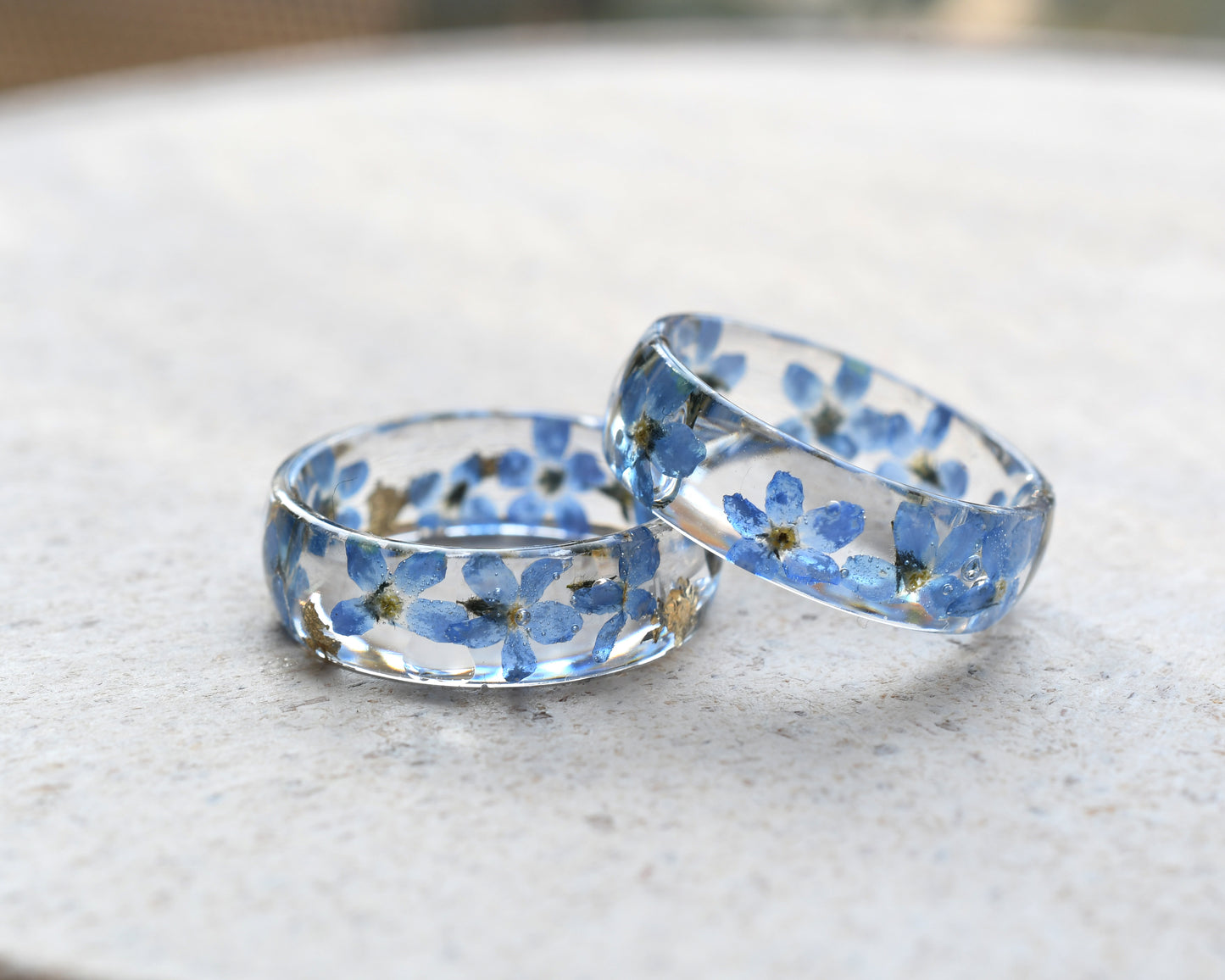 Smooth resin band combining delicate forget-me-nots with gold foil accents