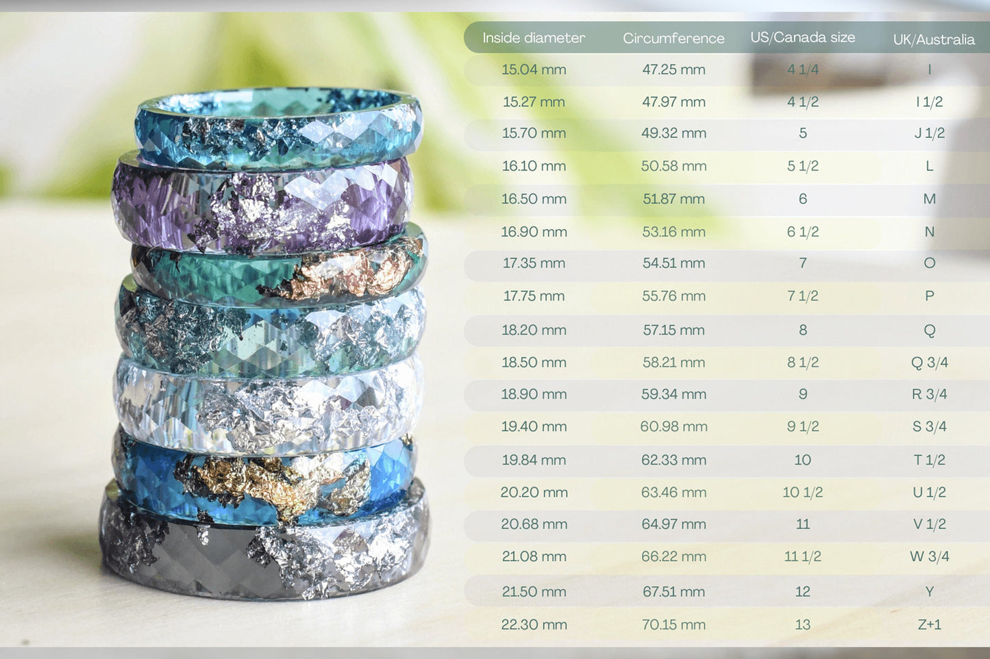 Stack of colorful rings with a size chart on a white background