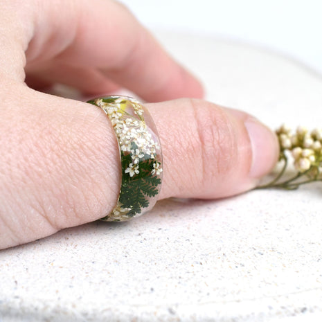 Botanical resin statement ring, wide 8 mm band, worn on finger