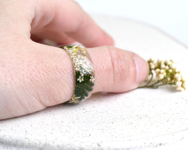 Botanical resin statement ring, wide 8 mm band, worn on finger