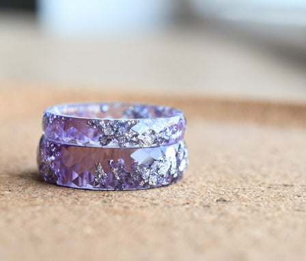 Purple ring with a textured design on a wooden surface