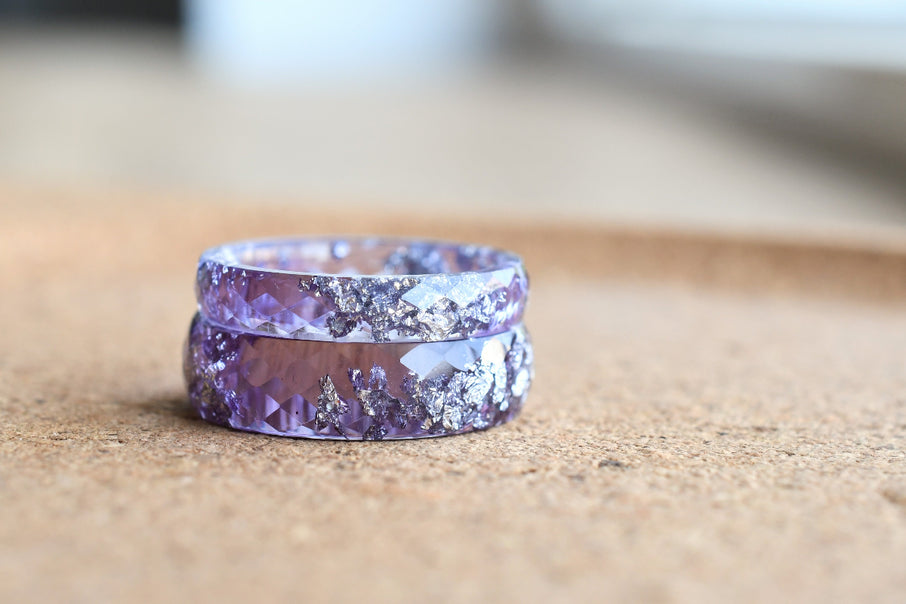 Purple ring with a textured design on a wooden surface