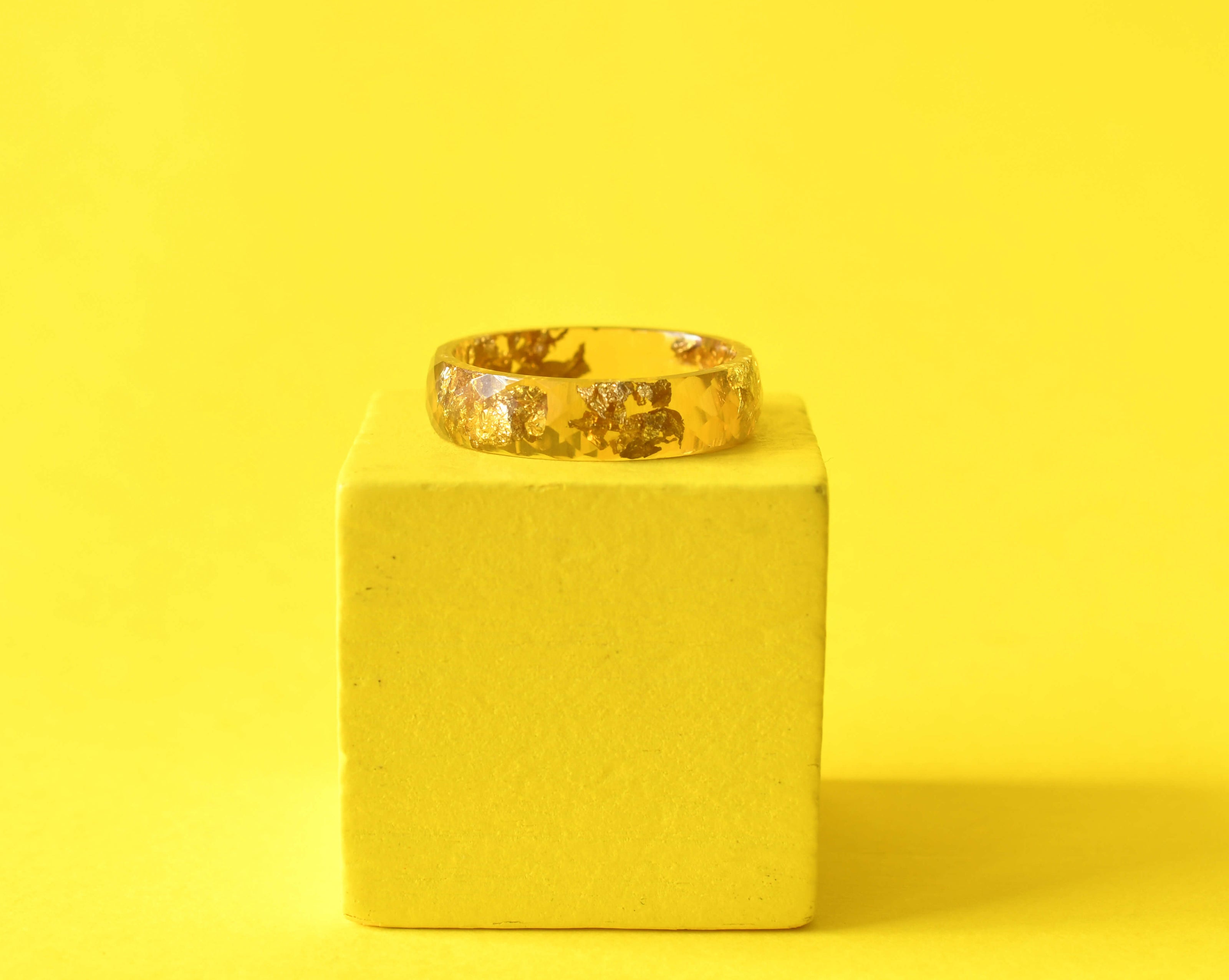 Flatlay of Solar Signal Ring showing gold leaf in vibrant yellow resin