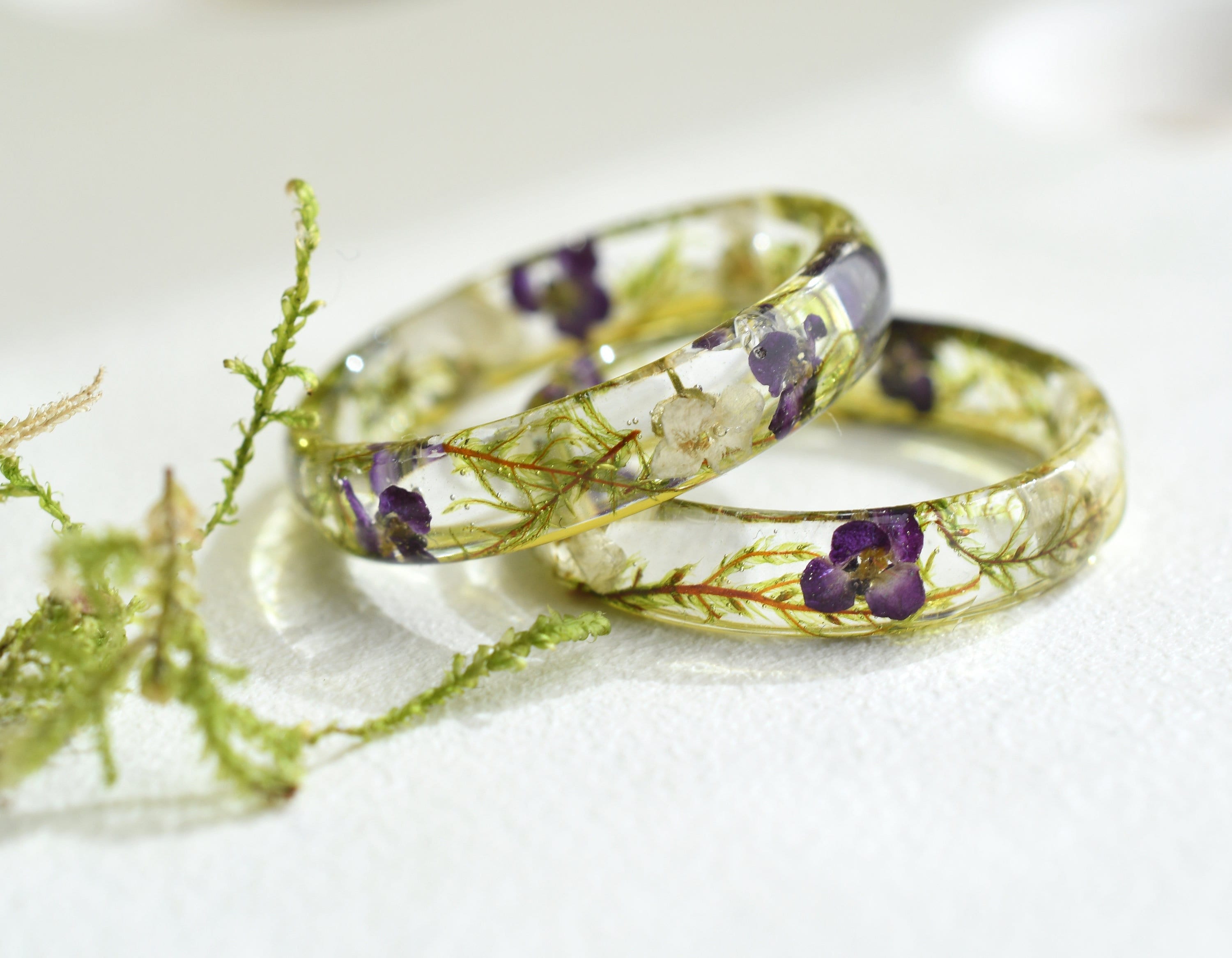 Resin ring with dried alyssum flowers and moss
