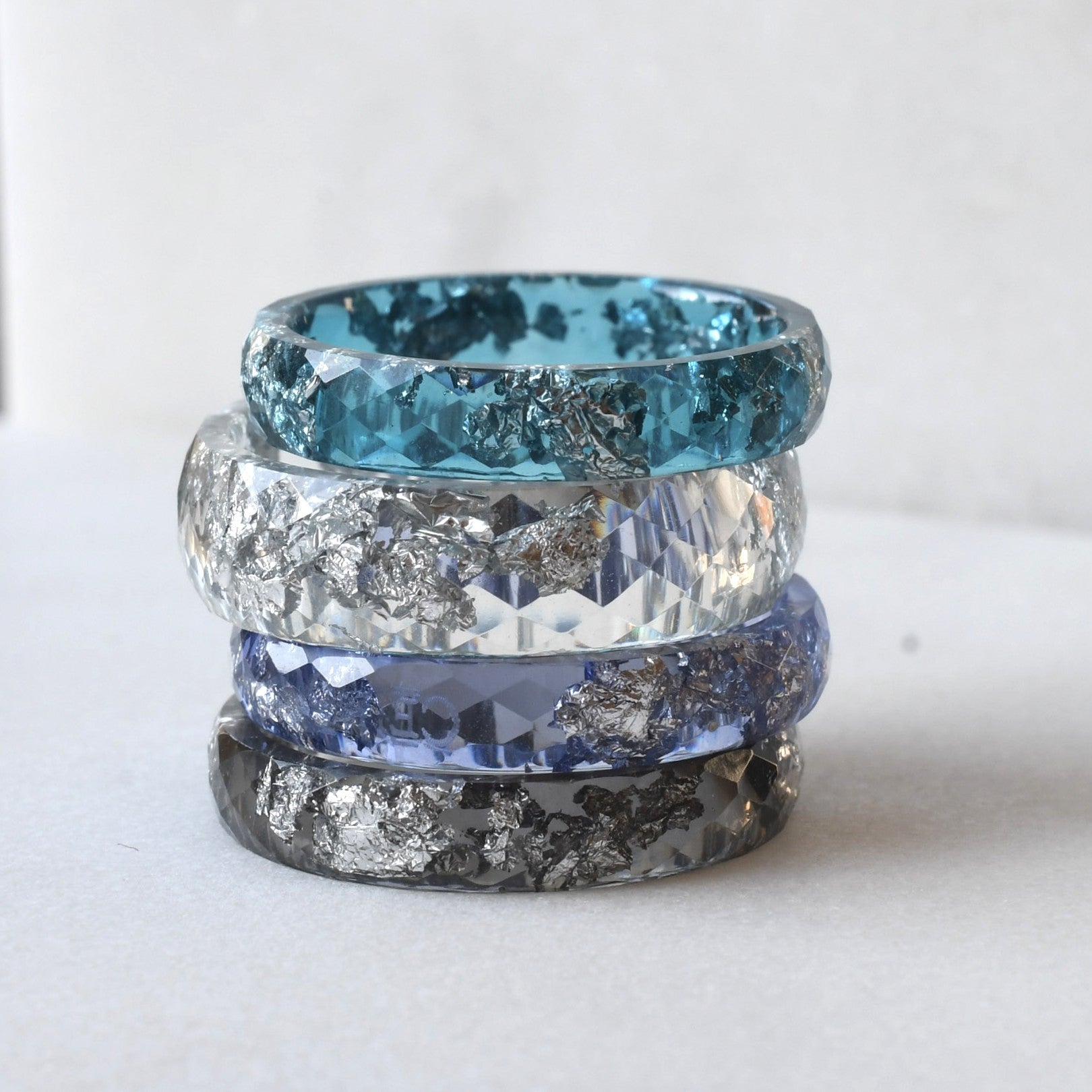 Resin stacking rings in blue, transparent, deep blue and black