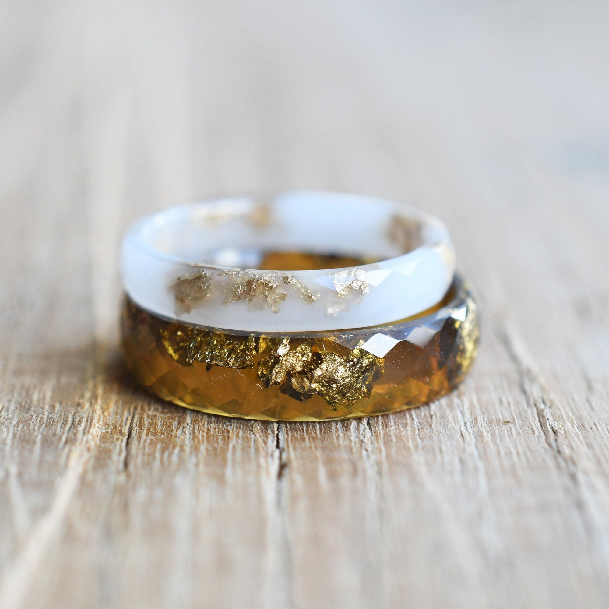Ring with gold leaf design on a wooden surface
