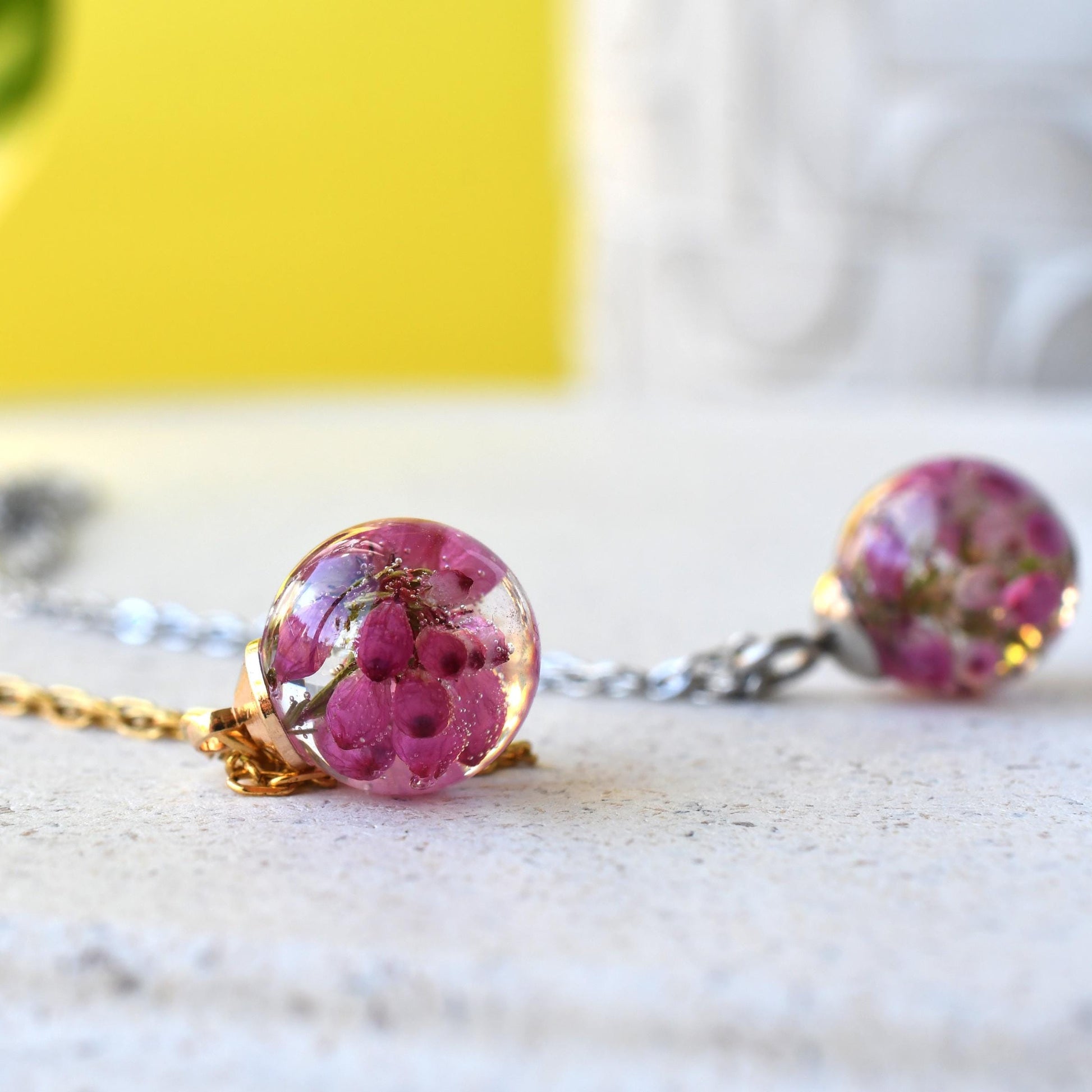 Side view of spherical pendant with clear resin and floral inclusion