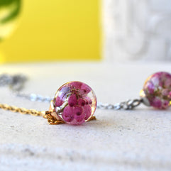 Side view of spherical pendant with clear resin and floral inclusion