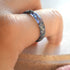 Close-up of amethyst colored resin ring showing shimmering silver leaf texture