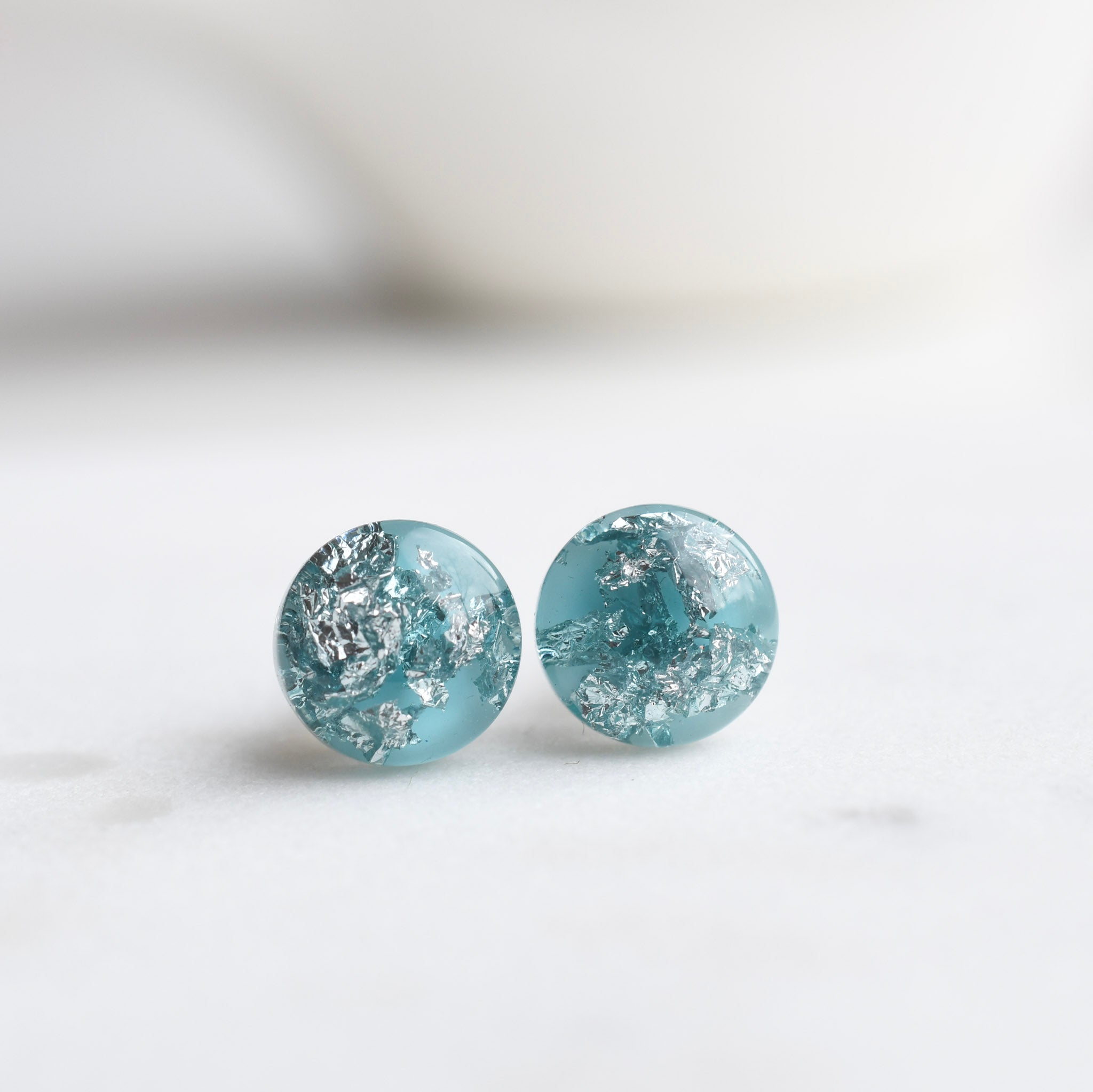 Aqua blue resin stud earrings with silver leaf handmade by Resity