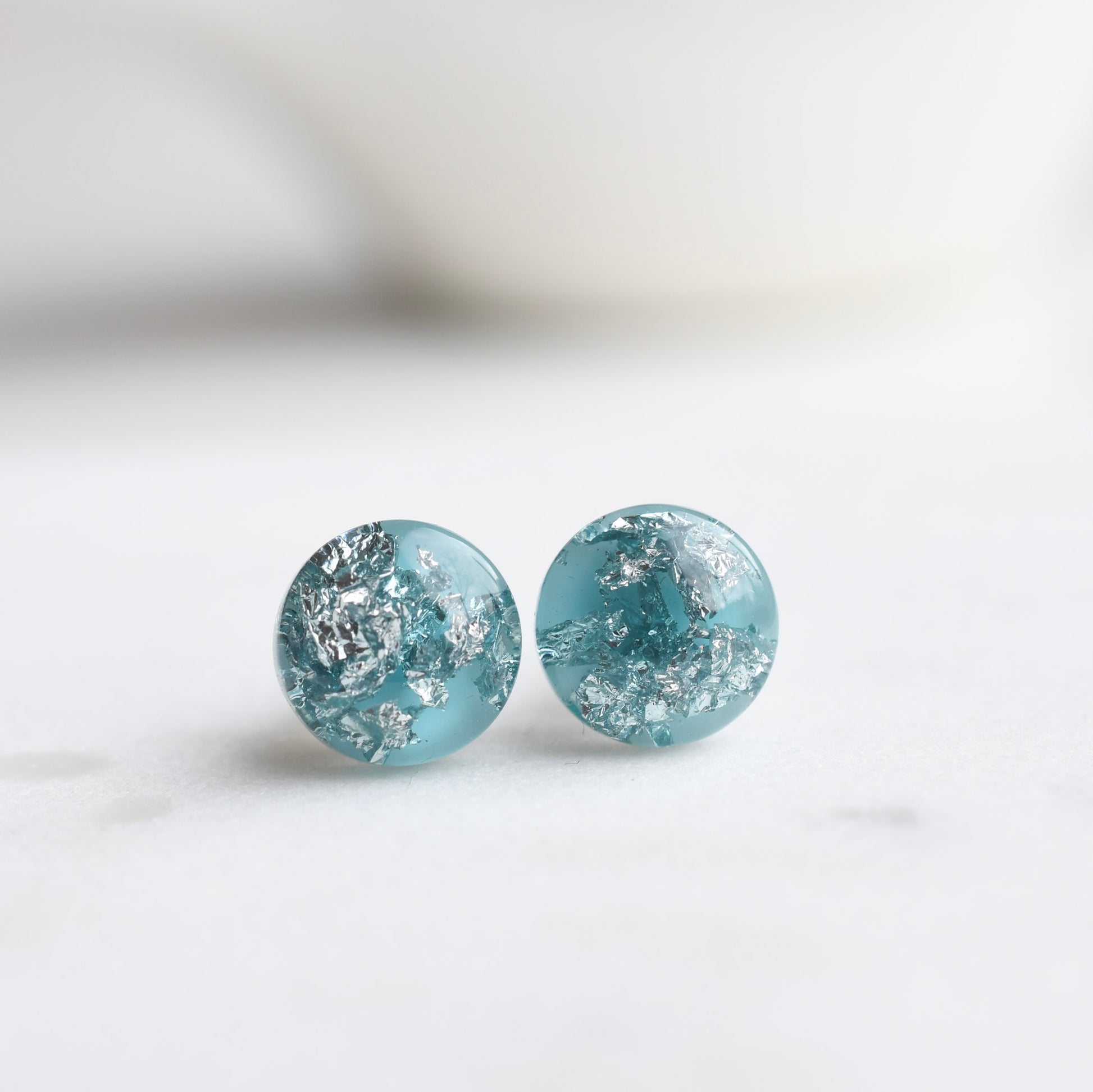 Aqua blue resin stud earrings with silver leaf handmade by Resity