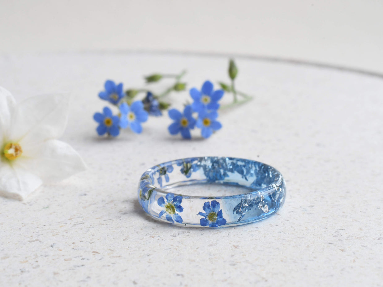 Aqua resin ring with real forget-me-not flowers and silver flakes