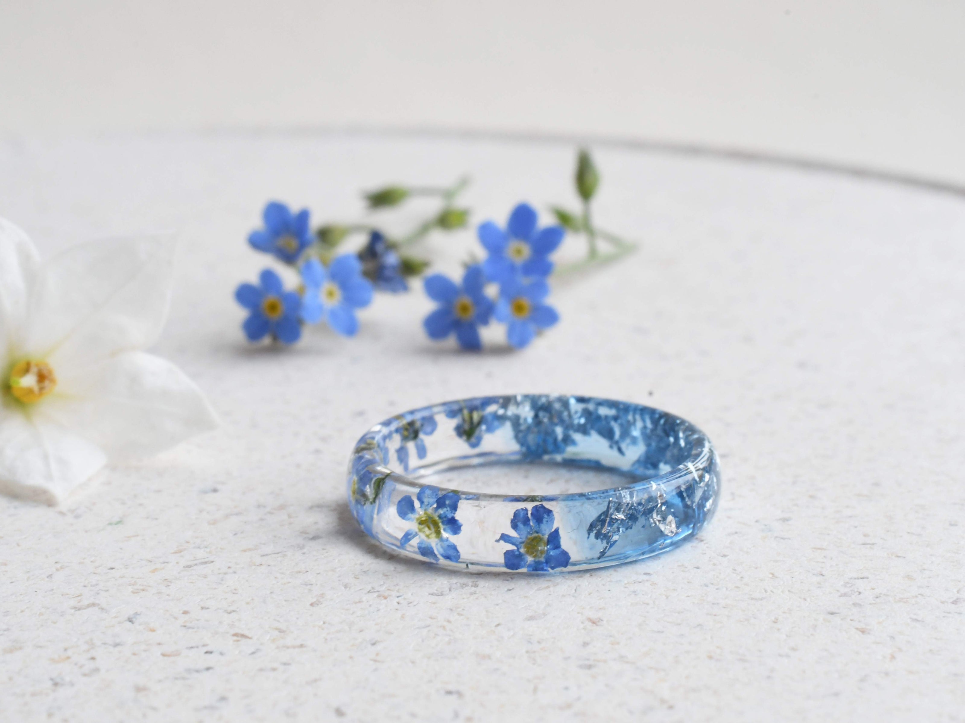 Aqua resin ring with real forget-me-not flowers and silver flakes