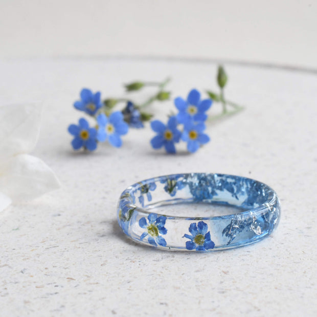 Aqua resin ring with real forget-me-not flowers and silver flakes