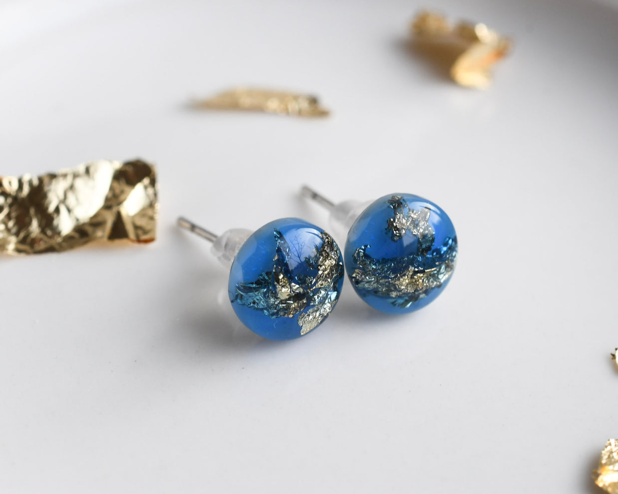 Blue resin stud earrings with gold leaf handmade by Resity in Vienna