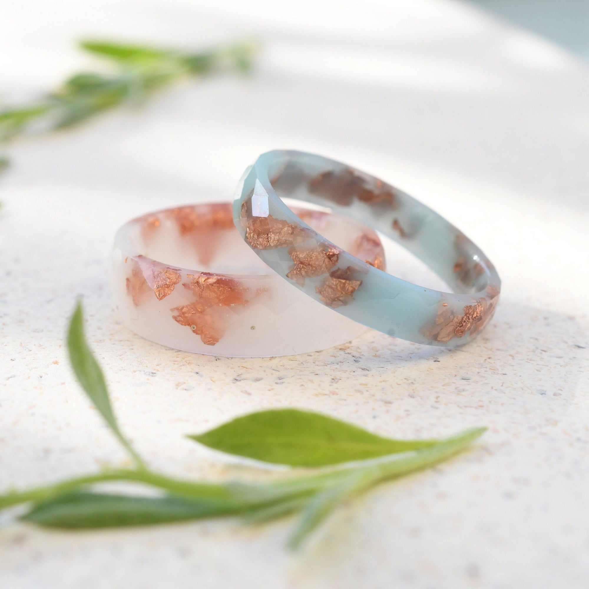 Thin faceted baby blue resin ring with shimmering rose gold flakes
