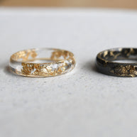 Close-up of smooth resin rings with gold leaf flakes handmade in Vienna