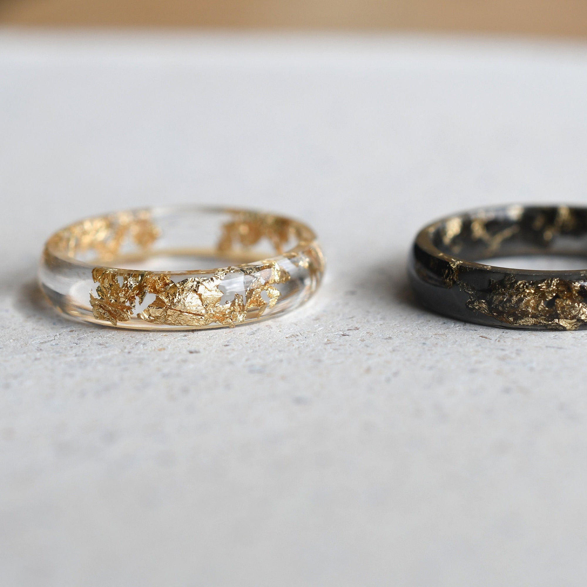 Close-up of smooth resin rings with gold leaf flakes handmade in Vienna