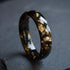 Black faceted men’s band with metallic gold flakes