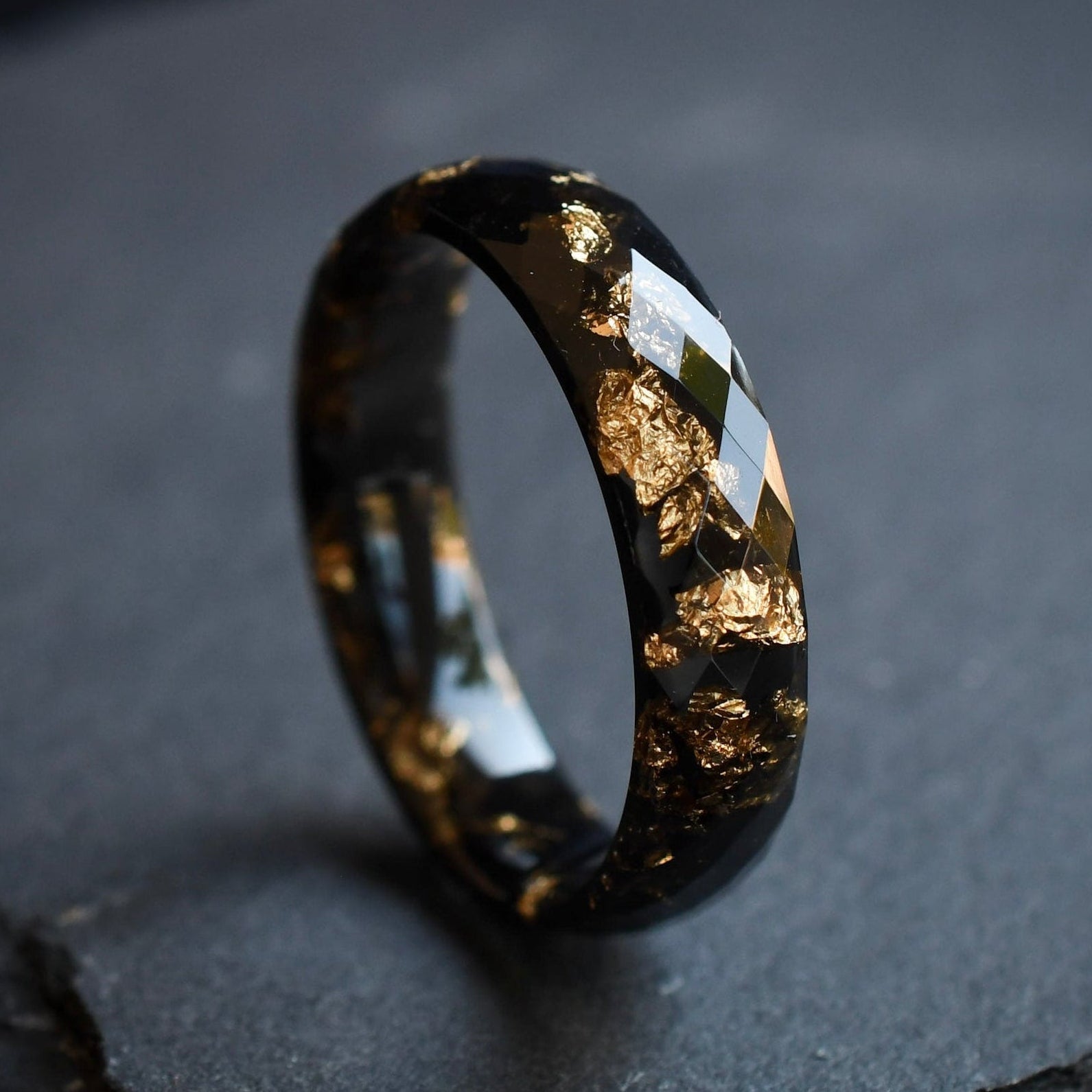 Black faceted men’s band with metallic gold flakes