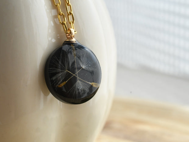 Black resin pendant with real dandelion seed on gold chain, handmade symbolic necklace