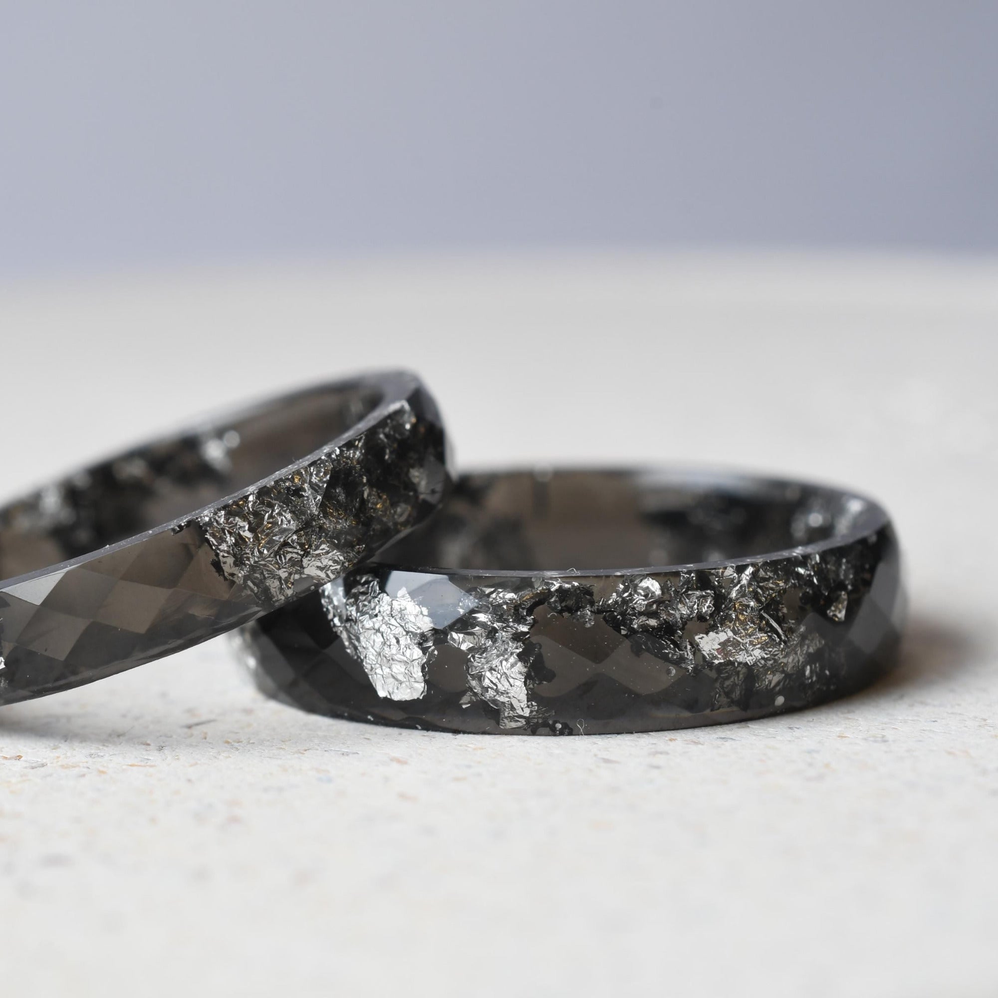 Faceted black resin rings with shimmering silver flakes — unisex design