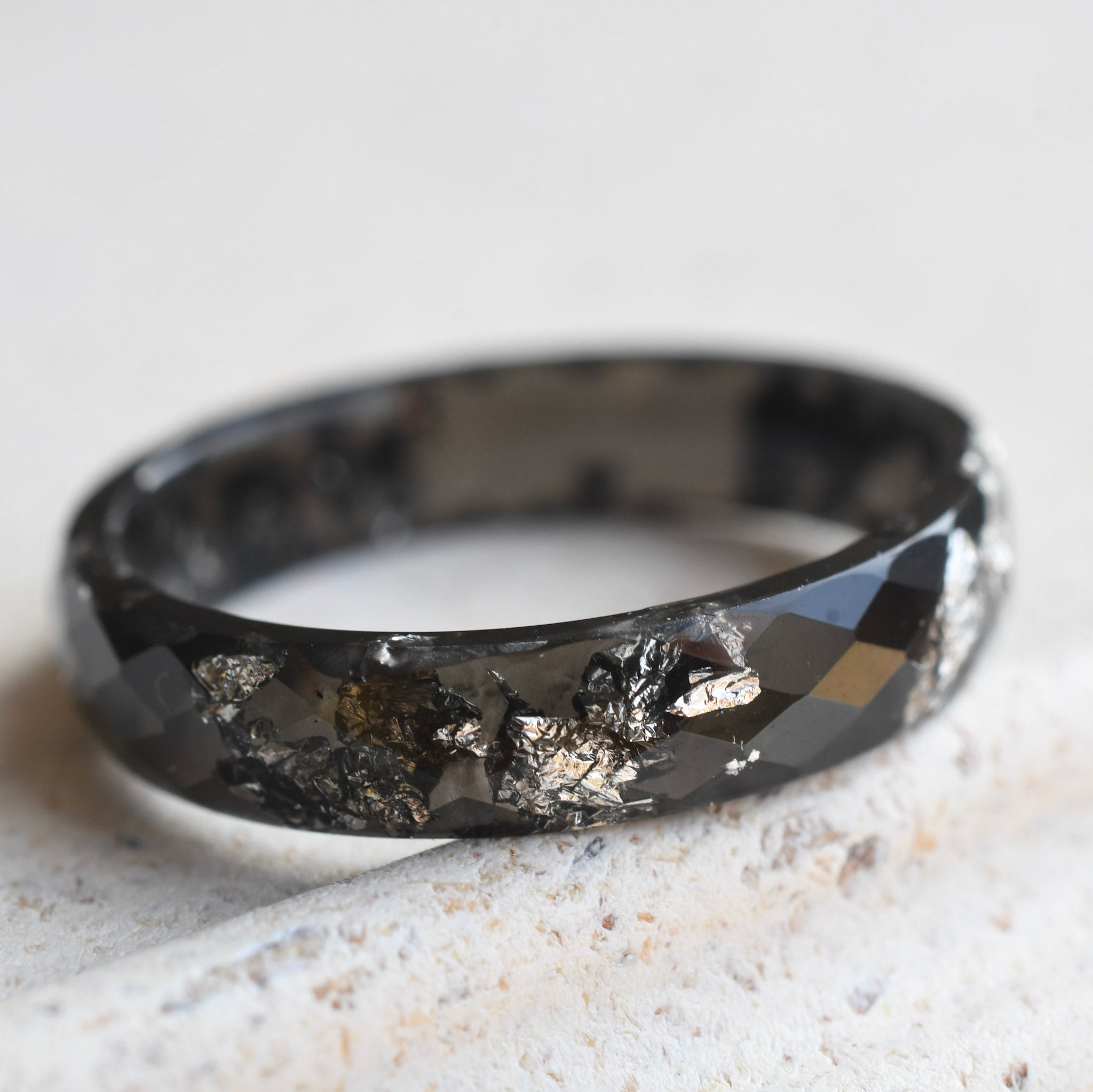 Slim faceted black resin stacking ring with metallic silver leaf handmade in Vienna