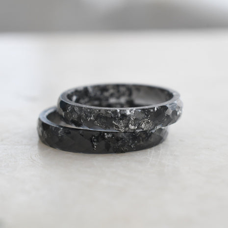 Thin black faceted resin ring with shimmering silver flakes — minimalist jewelry