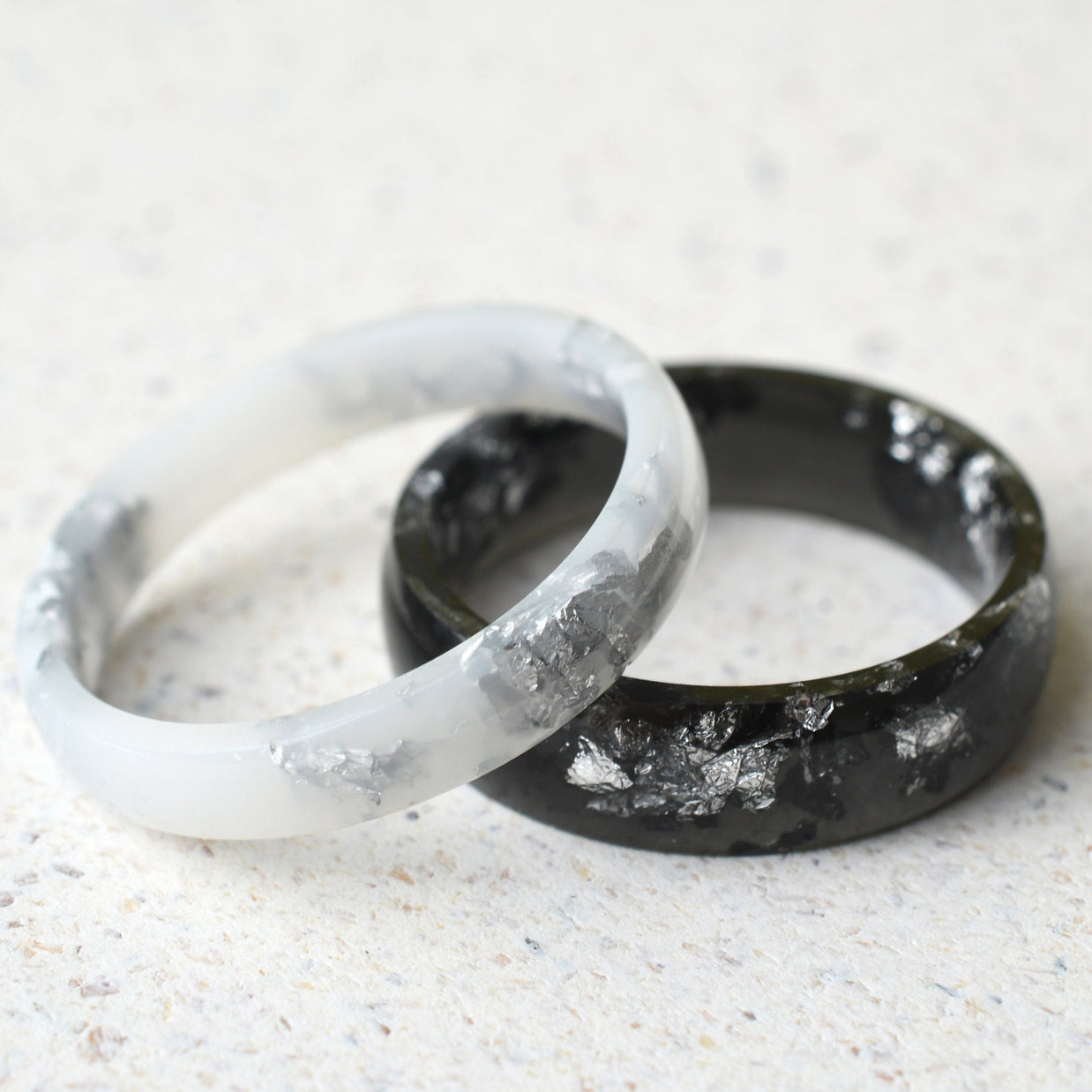 Smooth black and white resin rings with real silver leaf flakes — unisex design