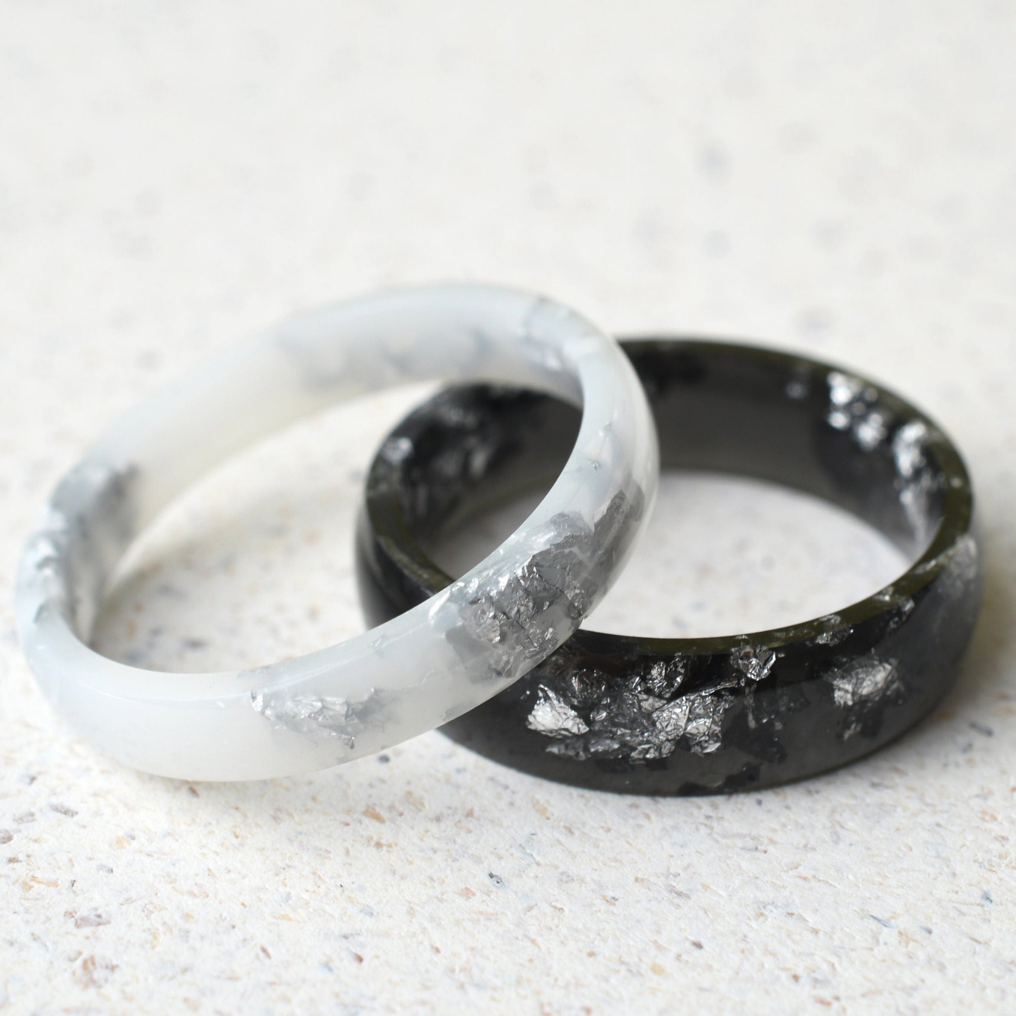 Smooth black and white resin rings with real silver leaf flakes — unisex design