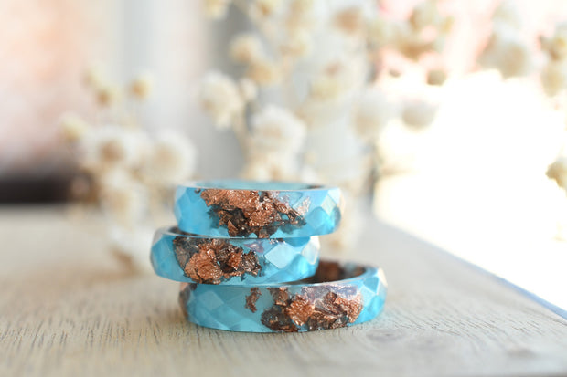 Flatlay of Blue Ember Ring showing rose gold leaf in vibrant blue matte resin