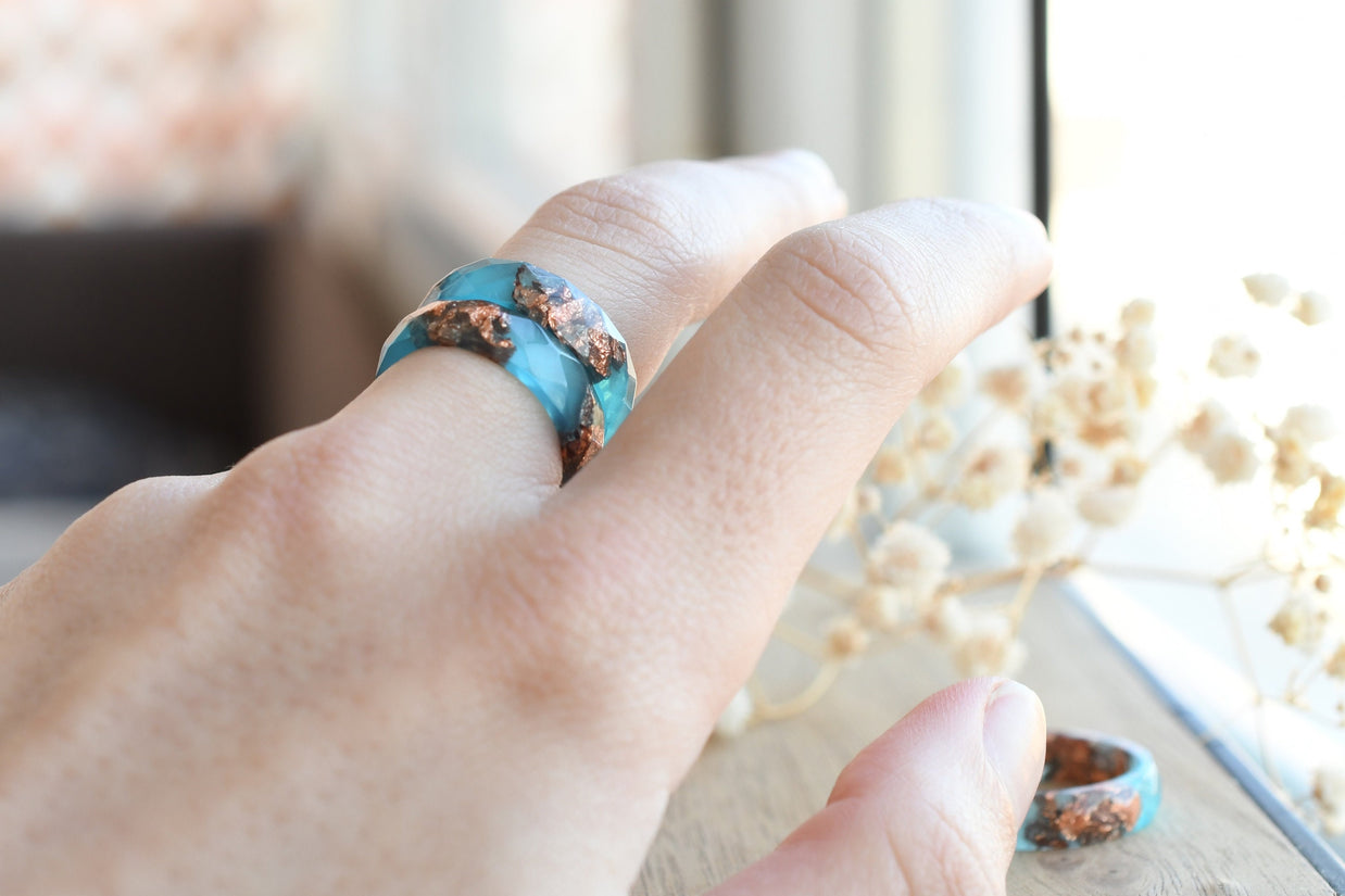 Blue Ember Ring worn on hand, highlighting dainty design and elegant color contrast