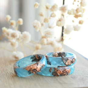 Blue Ember Ring stacked with other minimalist bands for a colorful, layered look