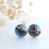 Deep blue resin stud earrings with rose gold flakes handmade by Resity in Vienna