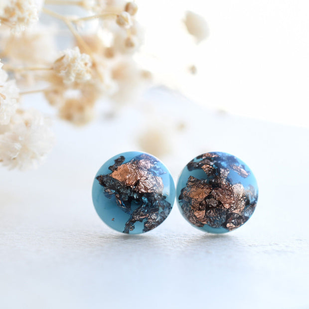 Deep blue resin stud earrings with rose gold flakes handmade by Resity in Vienna
