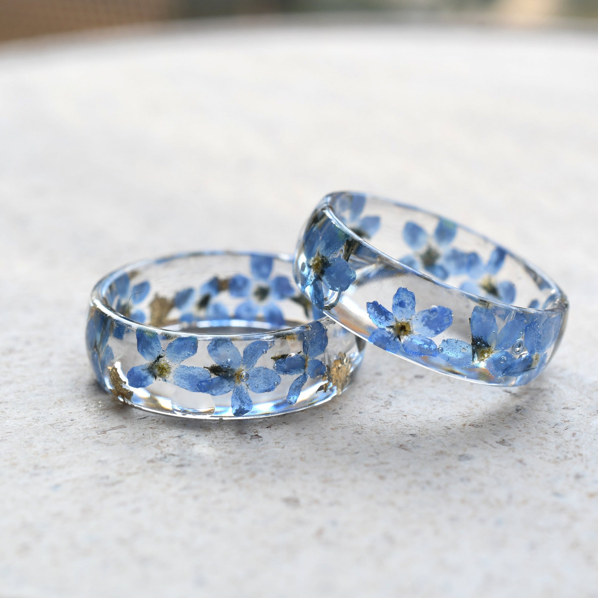 Smooth resin band combining delicate forget-me-nots with gold foil accents