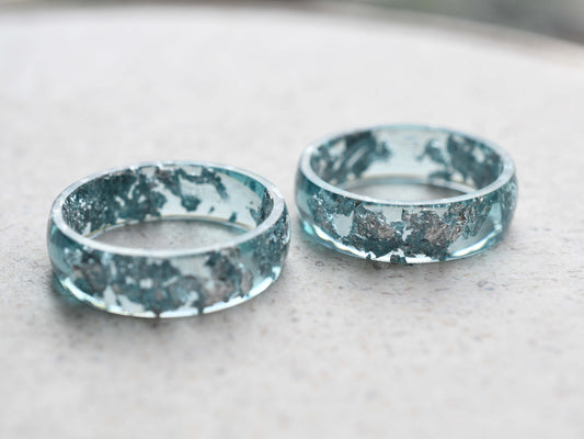 Close-up of silver leaf in blue resin ring