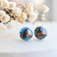 Handmade blue resin earrings with rose gold flakes displayed in gift box by Resity