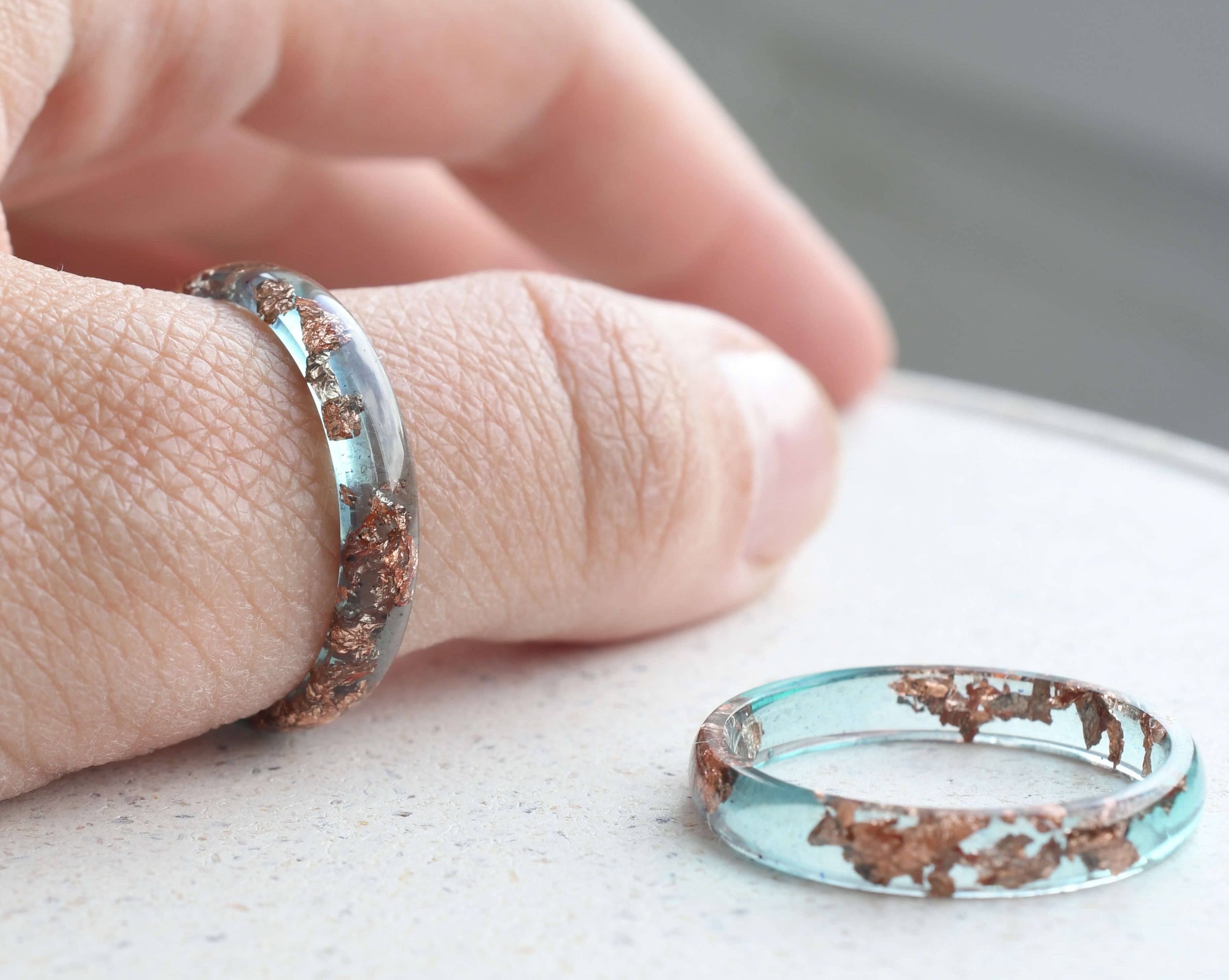 Minimalist stacking ring in ocean blue resin with delicate rose gold flakes