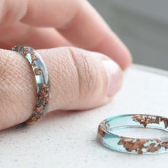 Minimalist stacking ring in ocean blue resin with delicate rose gold flakes