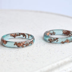 Blue resin ring with shimmering rose gold leaf — minimalist handmade jewelry from Austria