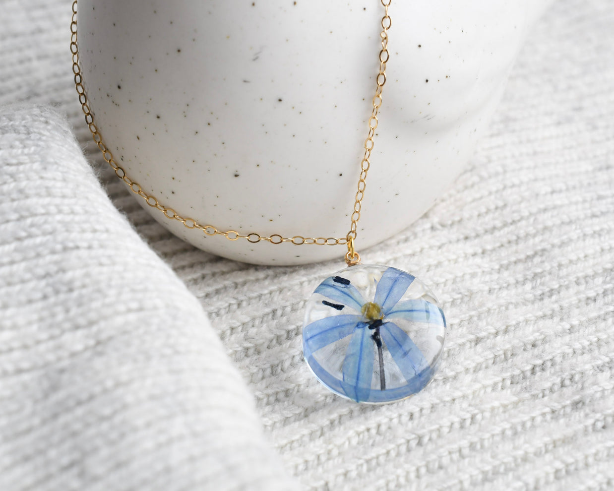 Blue squill flower preserved in resin and set on a gold-filled chain