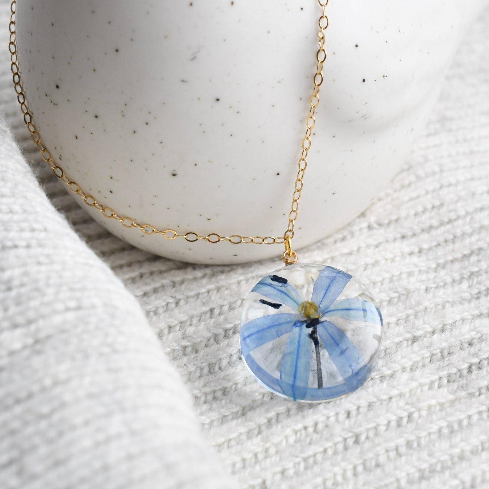 Blue squill flower preserved in resin and set on a gold-filled chain