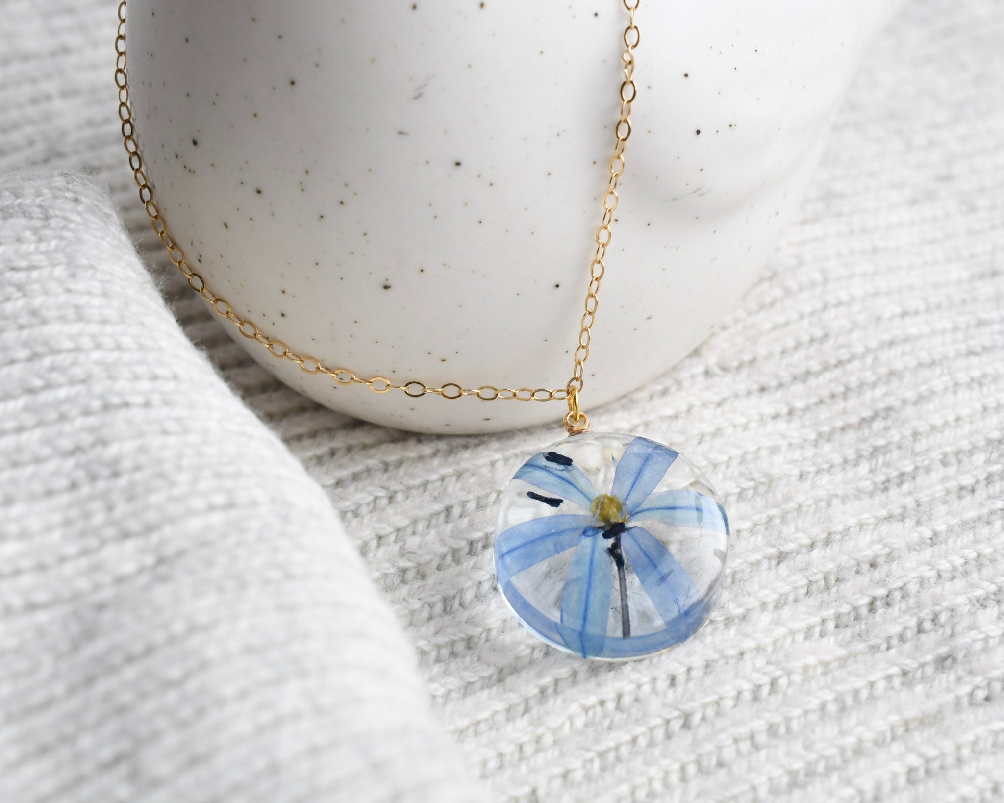 Blue squill flower preserved in resin and set on a gold-filled chain