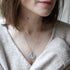Blue Whisper Necklace — real blue flower pendant handmade in Vienna by Resity worn by model