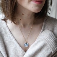 Blue Whisper Necklace — real blue flower pendant handmade in Vienna by Resity worn by model