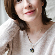 Nature-inspired handcrafted necklace worn — botanical pendant with moss, mushroom, and delicate flowers by Resity