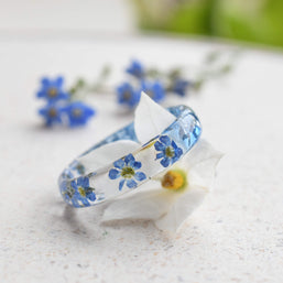 Botanical resin ring with blue forget-me-nots preserved in clear resin