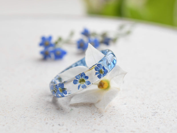 Botanical resin ring with blue forget-me-nots preserved in clear resin