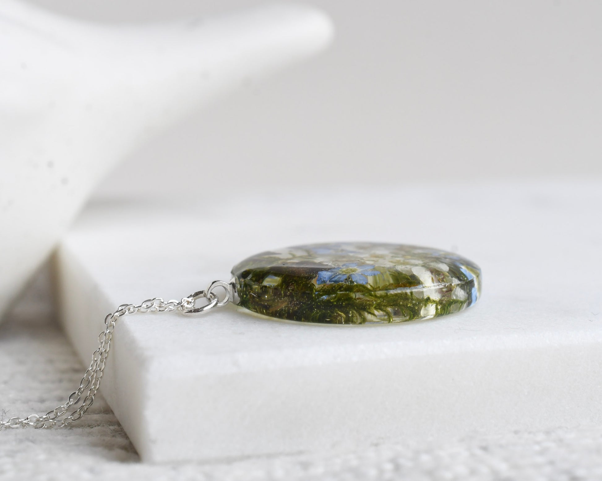 Botanical terrarium necklace with mushrooms, moss, and forget-me-nots